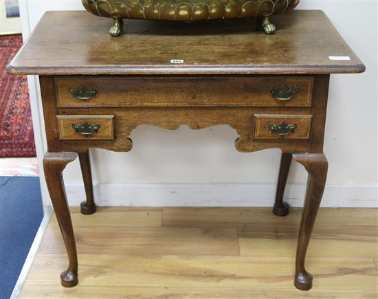 A mid 18th century oak and crossbanded lowboy